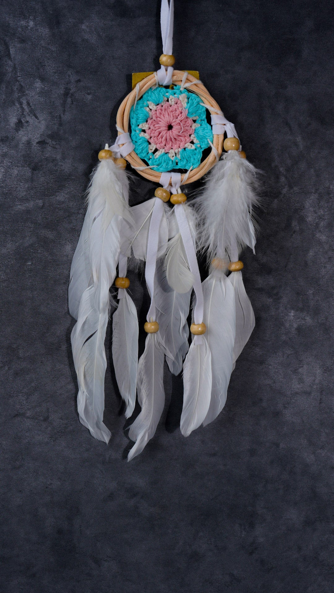 Hand-crocheted cotton mandala dream-catcher in rattan hoop with flowing white feathers and wood beads.