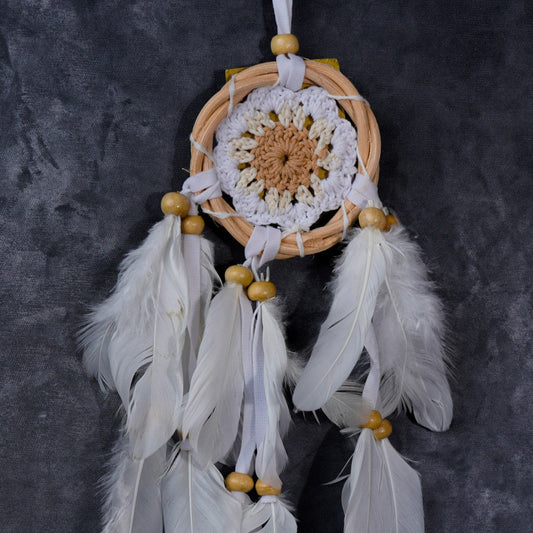 Hand-crocheted cotton mandala dream-catcher in rattan hoop with flowing white feathers and wood beads.