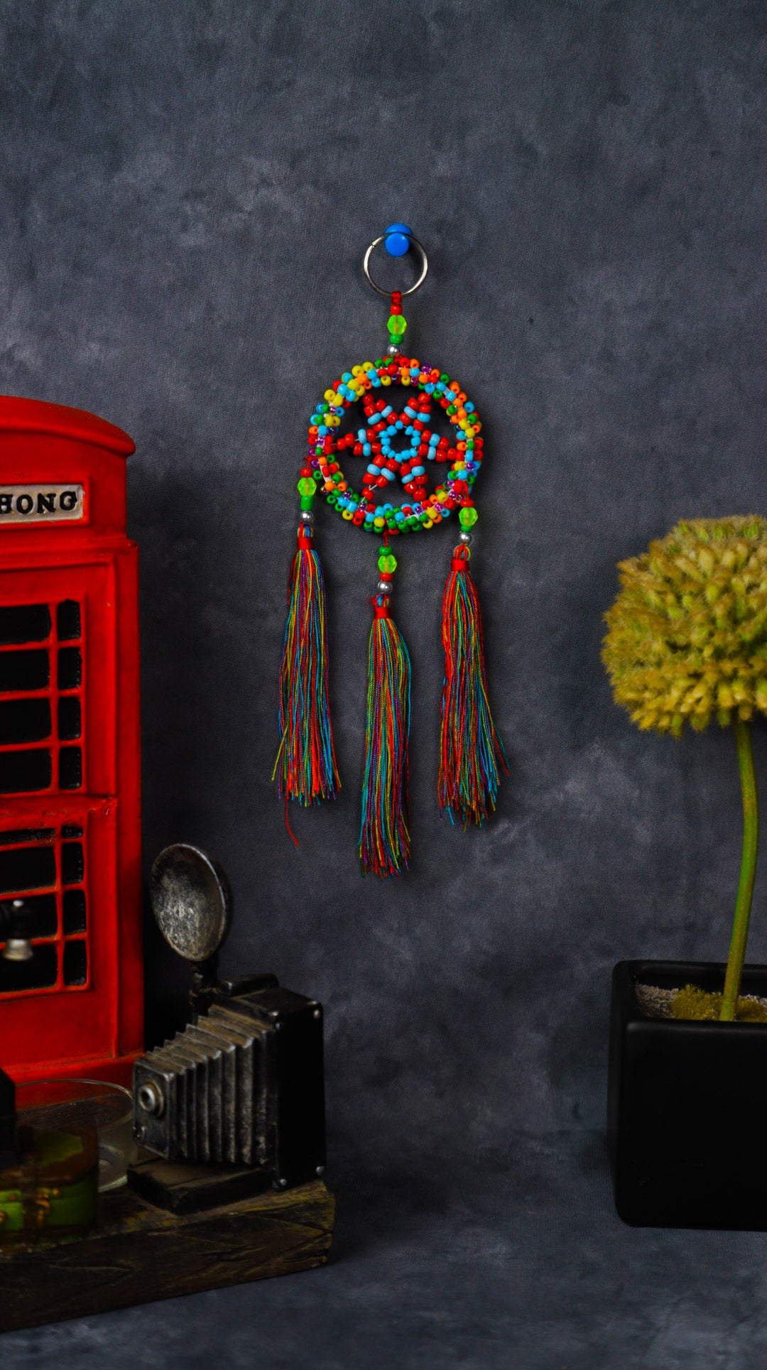 Turquoise beaded dreamcatcher keychain with triple tassels hanging on split ring.