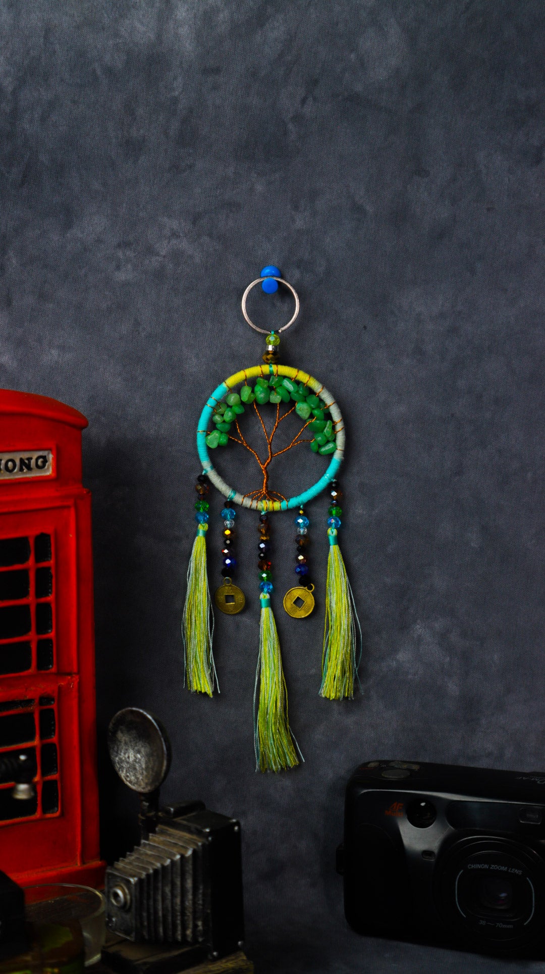 Turquoise-wrapped Tree of Life dreamcatcher keychain with green stone leaves and teal tassels.