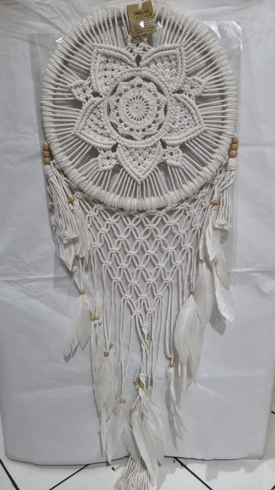 Bohemian macrame dreamcatcher with lotus flower mandala, featuring natural cotton rope, wood beads, and white feathers.