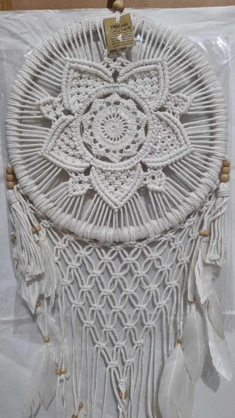Bohemian macrame dreamcatcher with lotus flower mandala, featuring natural cotton rope, wood beads, and white feathers.