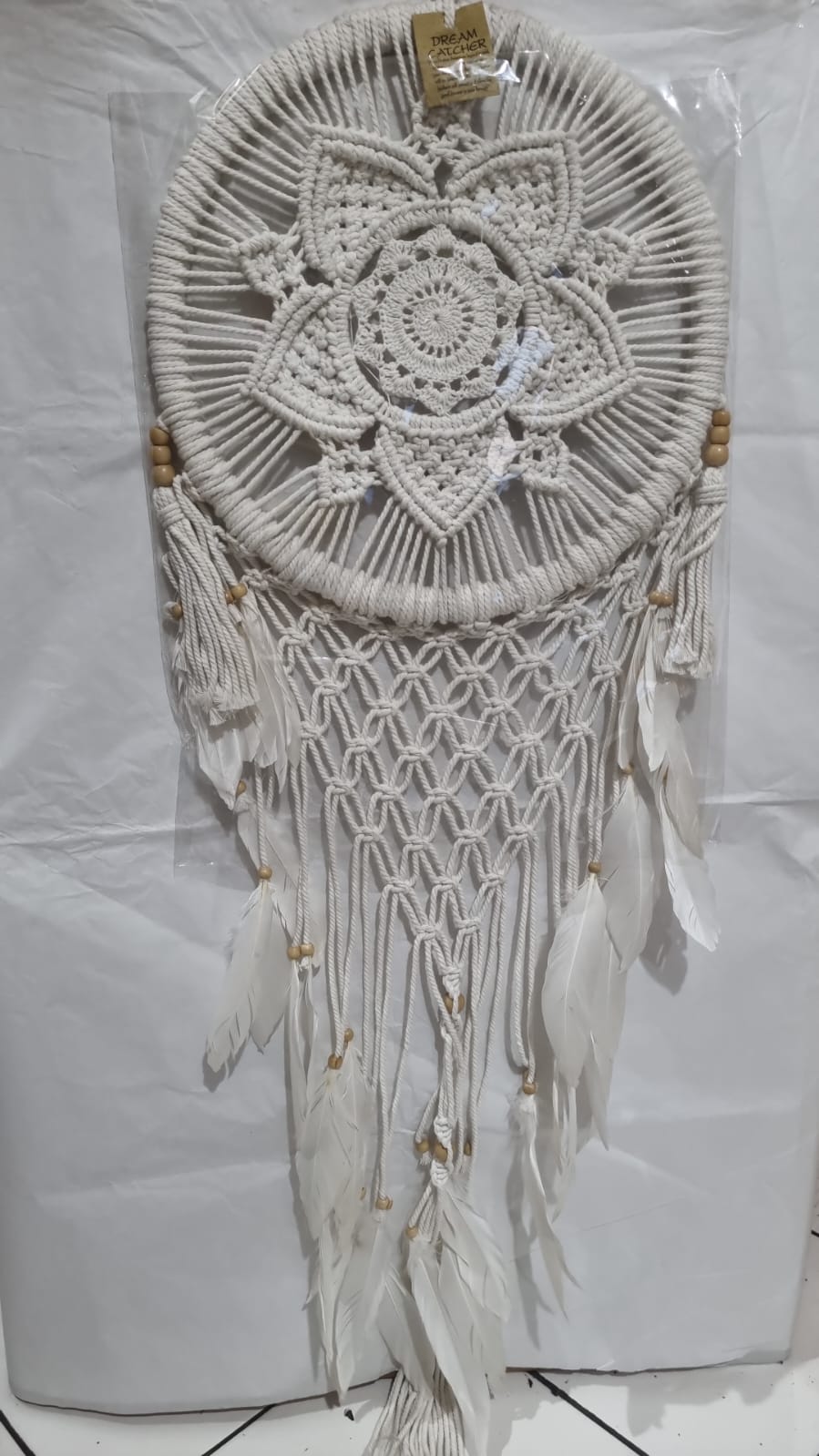 Bohemian macrame dreamcatcher with lotus flower mandala, featuring natural cotton rope, wood beads, and white feathers.