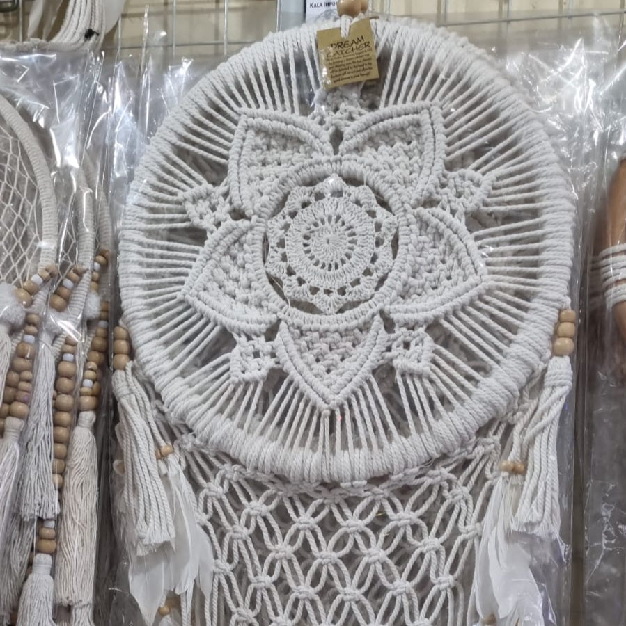 Bohemian macrame dreamcatcher with lotus flower mandala, featuring natural cotton rope, wood beads, and white feathers.