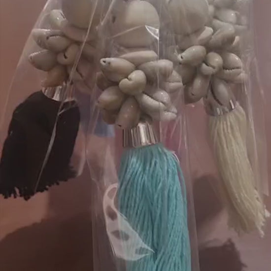 Handcrafted dreamcatcher keychain with wooden beads, shells, and colorful tassel