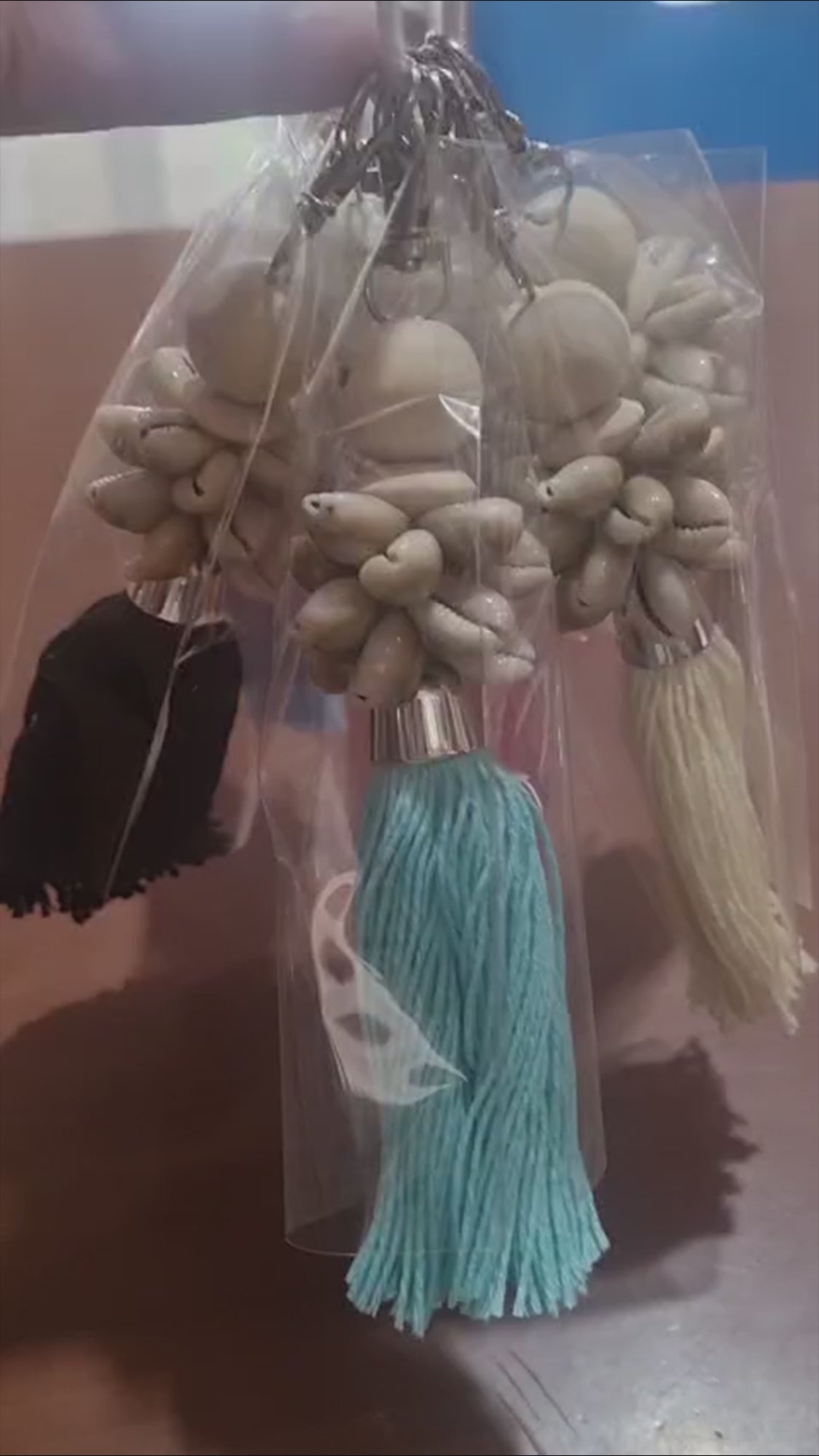 Handcrafted dreamcatcher keychain with wooden beads, shells, and colorful tassel