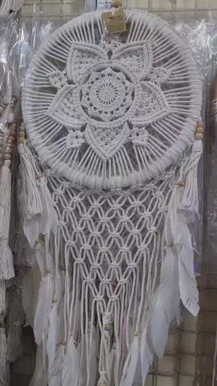 Bohemian macrame dreamcatcher with lotus flower mandala, featuring natural cotton rope, wood beads, and white feathers.