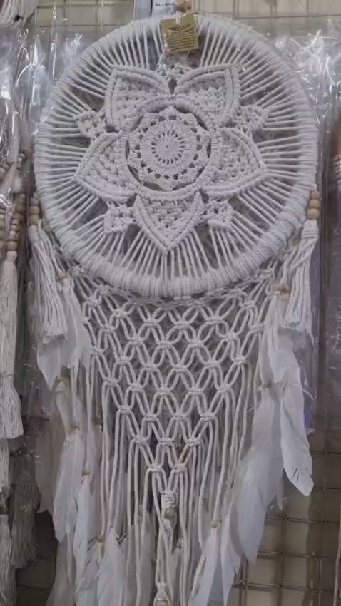 Bohemian macrame dreamcatcher with lotus flower mandala, featuring natural cotton rope, wood beads, and white feathers.