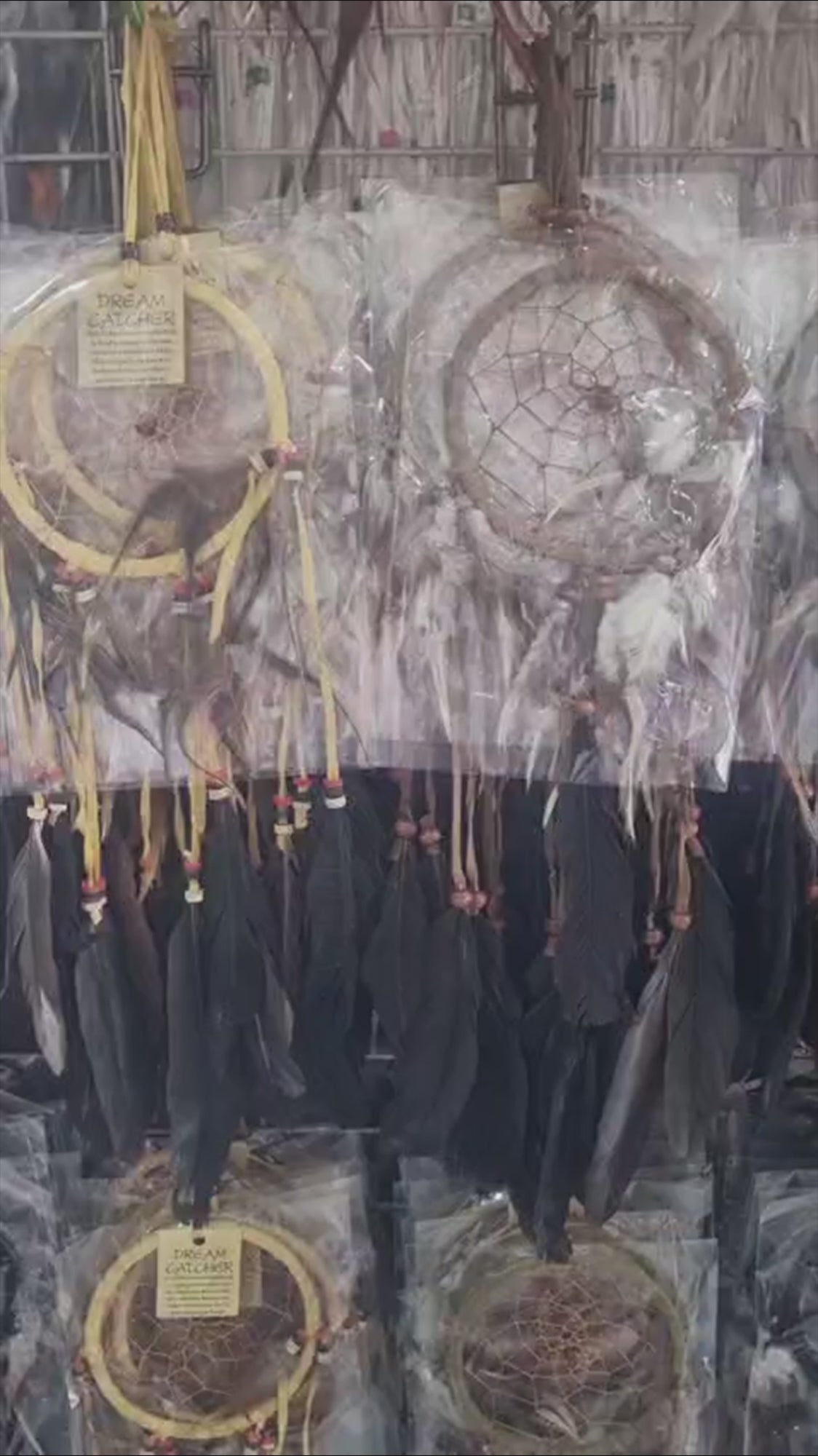 Artisan handmade dreamcatcher with cotton wrap, feathers, and wooden beads, 12cm diameter