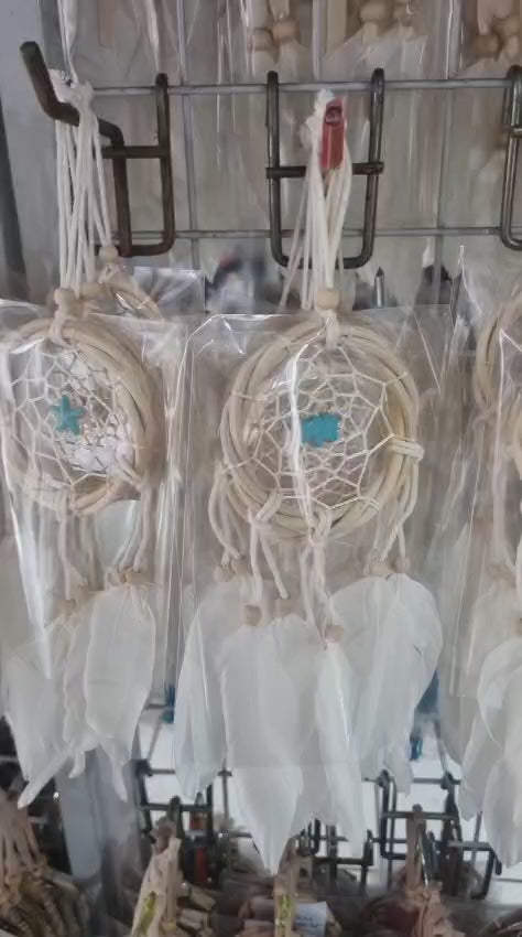 Small handmade rattan dreamcatcher 6 cm with white feathers, ideal for boho home or car decoration.