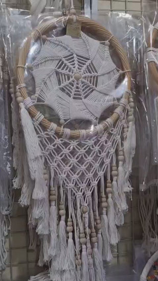 Rattan dreamcatcher with cotton spiral web and tassels, featuring wooden beads, perfect for boho wall décor or gifting.