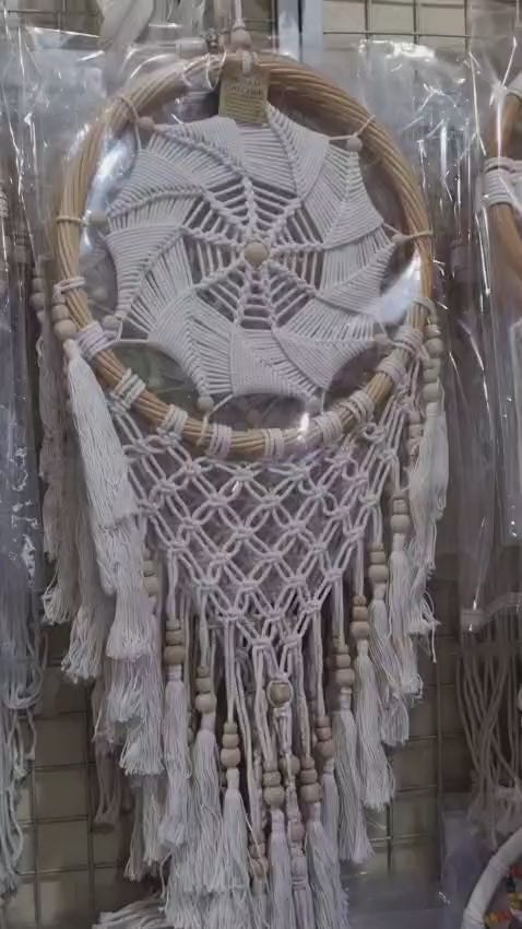 Rattan dreamcatcher with cotton spiral web and tassels, featuring wooden beads, perfect for boho wall décor or gifting.